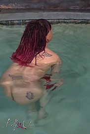 Naked shemale in an indoor pool